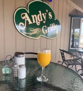 orange juice mimosa on the patio of andy's grille